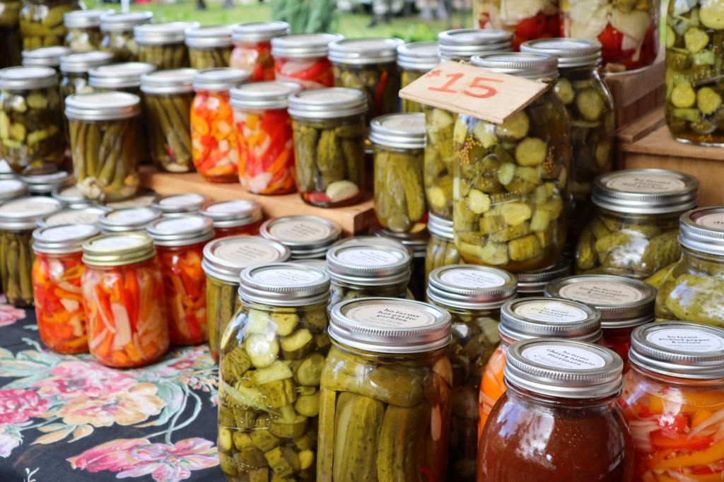 A display of jars of pickled vegetables.