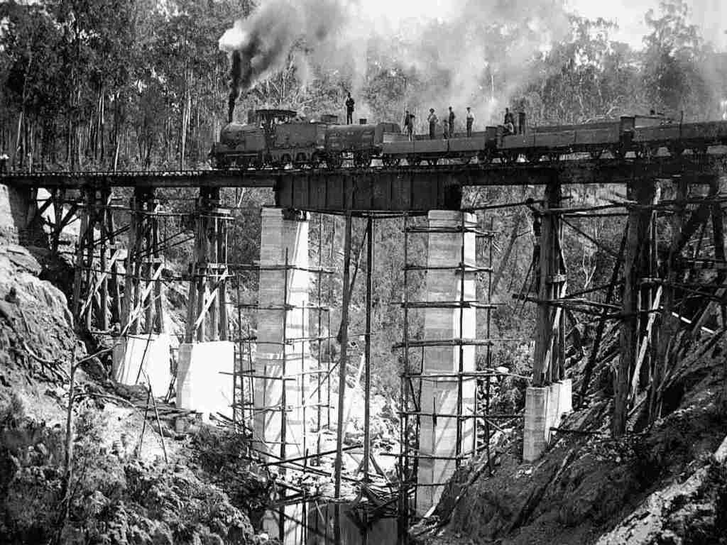 A steam train crossing a bridge.