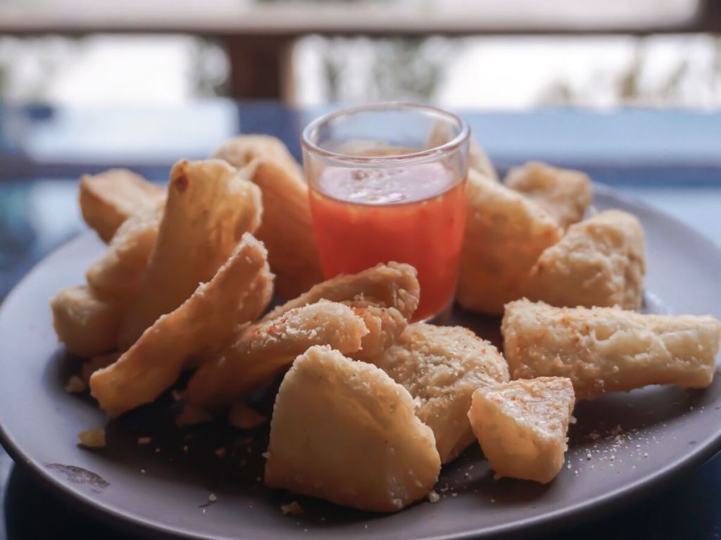 A plate of fried food with dipping sauce.