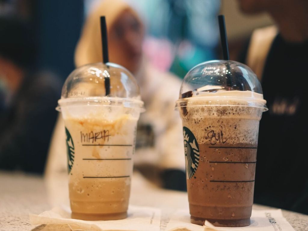 Two cups of Starbucks specialty coffee.