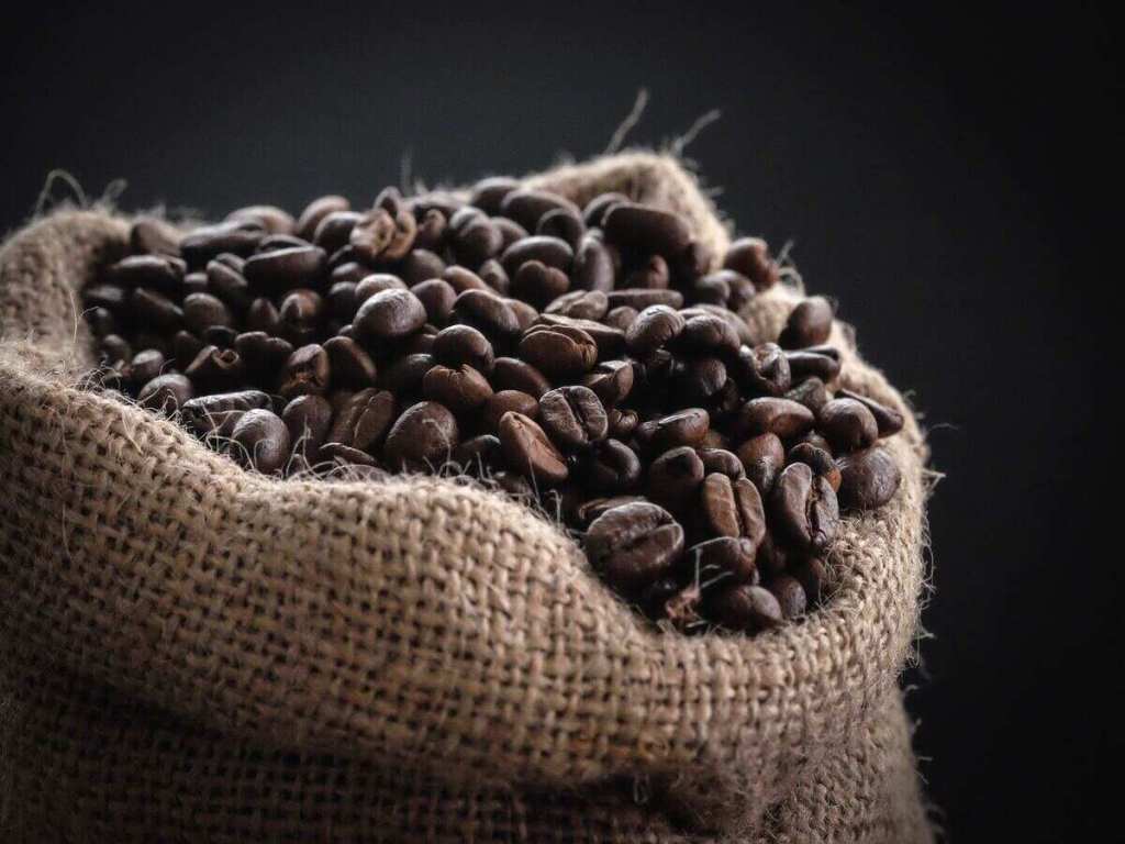 An open sack of coffee beans.