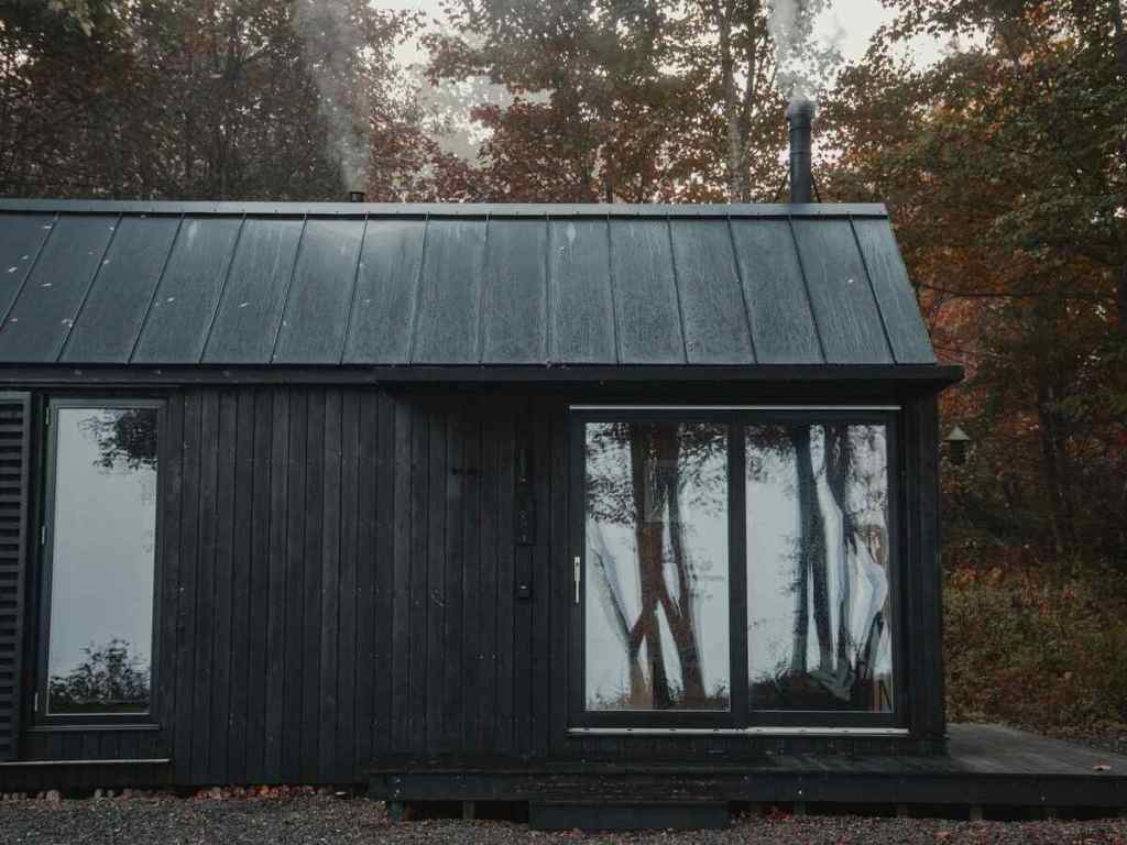 A wooden house with large windows.