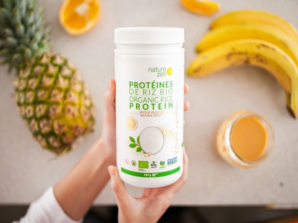 A box of protein shakes with fruits in the background.