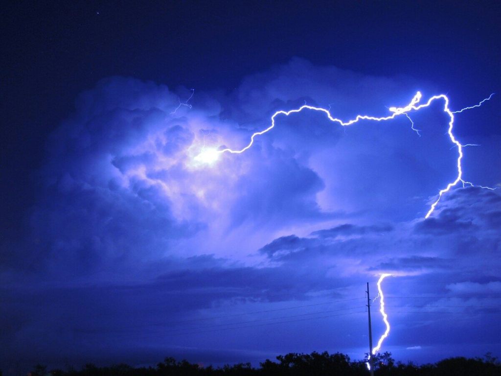 Storm clouds with lightening on the horizon.