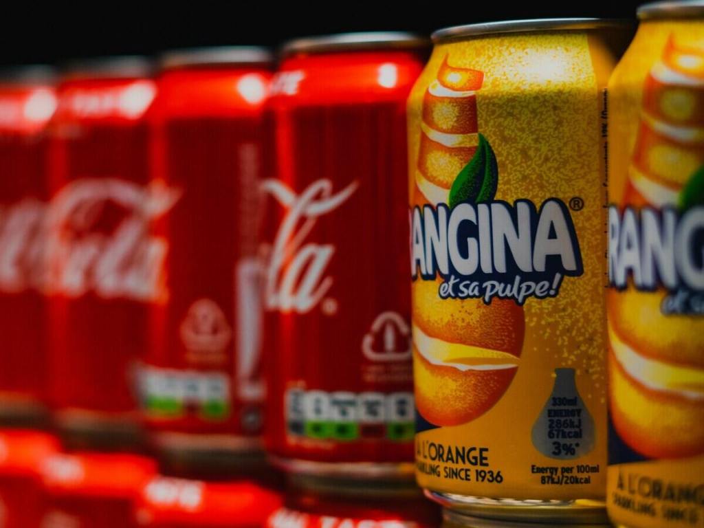 Coca-Cola and Orangina cans.
