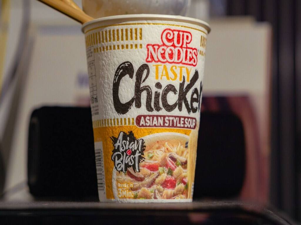 A cup of instant noodles with chicken flavor.