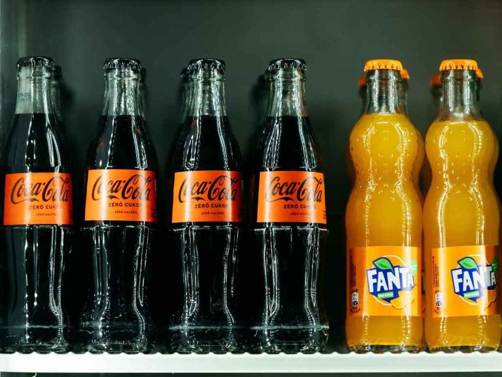 Coco-Cola and Orange Fanta bottles.