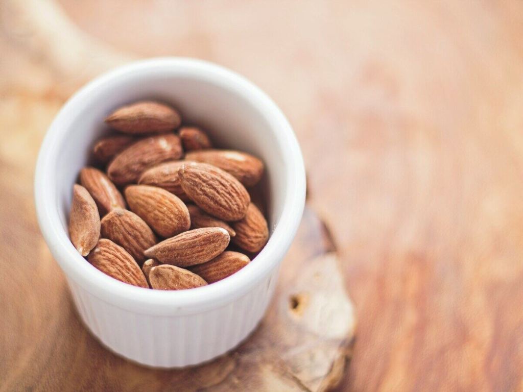 A small white bowl of almonds.