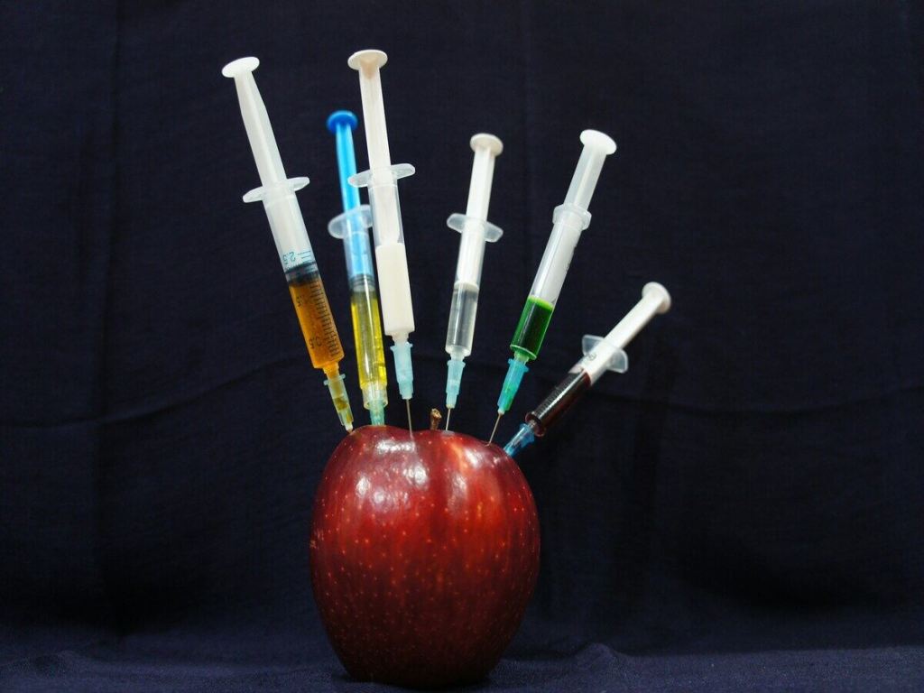 Apple being injected with various liquids.