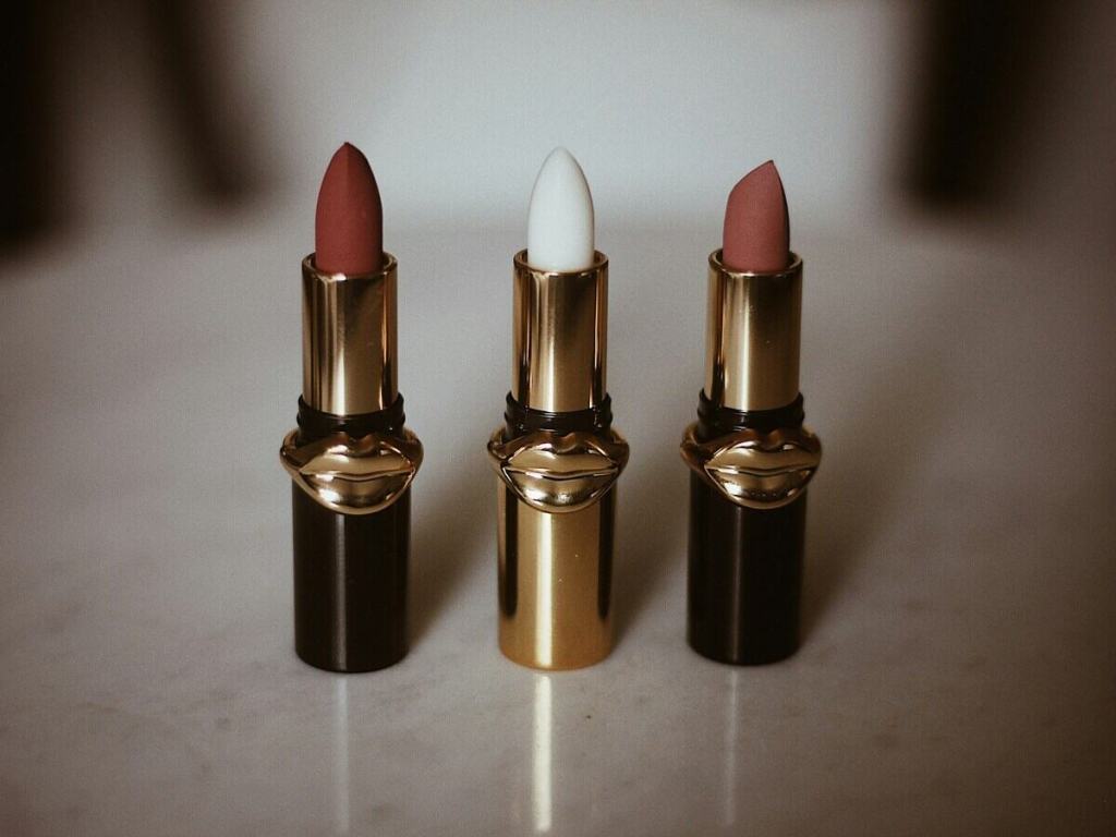 A selection of three lipsticks with different colors.