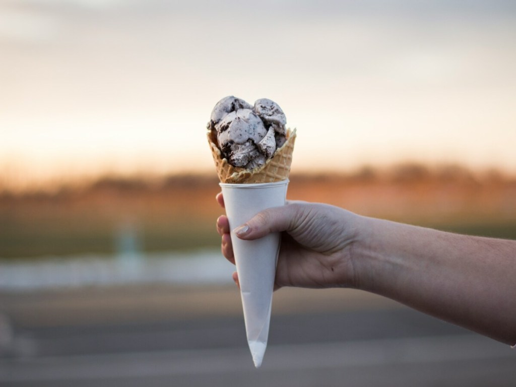 A person holding an ice cream.