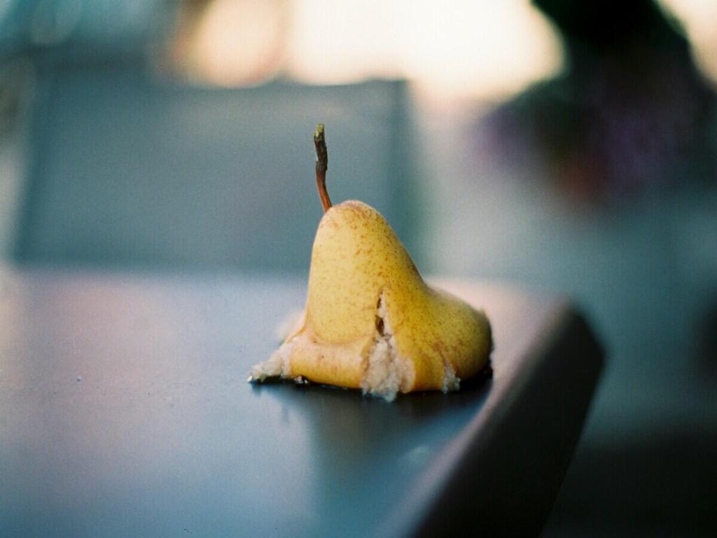 A smashed pear on the table.